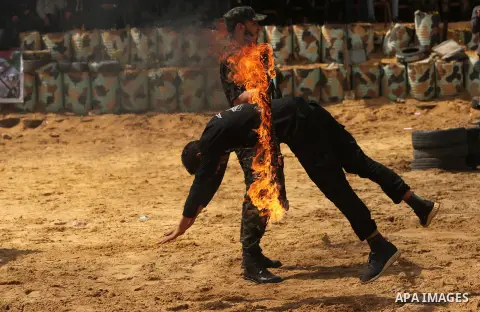 Palestinian high-school students show off their skills during a graduation ceremony from a military school course organised by the Palestinian security forces in Gaza strip, in Gaza City, on April 2, 2017. Photo by Ashra...