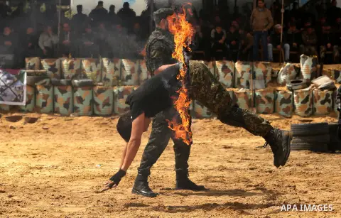 Palestinian high-school students show off their skills during a graduation ceremony from a military school course organised by the Palestinian security forces in Gaza strip, in Gaza City, on April 2, 2017. Photo by Ashra...