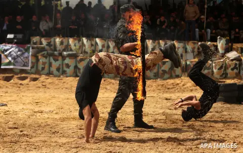 Palestinian high-school students show off their skills during a graduation ceremony from a military school course organised by the Palestinian security forces in Gaza strip, in Gaza City, on April 2, 2017. Photo by Ashra...