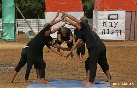Palestinian high-school students show off their skills during a graduation ceremony from a military school course organised by the Palestinian security forces in Gaza strip, in Gaza City, on April 2, 2017. Photo by Ashra...