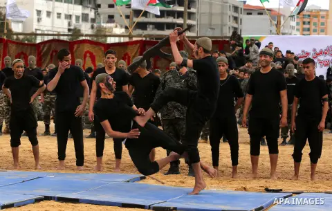 Palestinian high-school students show off their skills during a graduation ceremony from a military school course organised by the Palestinian security forces in Gaza strip, in Gaza City, on April 2, 2017. Photo by Ashra...