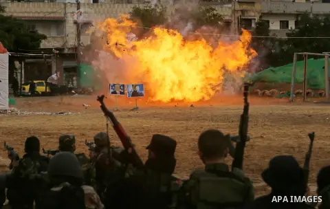 A fire is seen after a mock Israeli tank was blown up during a graduation ceremony from a military school course for Palestinian high-school students organised by the Palestinian security forces in Gaza strip, in Gaza Ci...