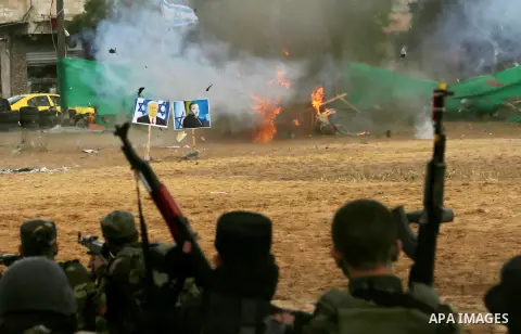 A fire is seen after a mock Israeli tank was blown up during a graduation ceremony from a military school course for Palestinian high-school students organised by the Palestinian security forces in Gaza strip, in Gaza Ci...