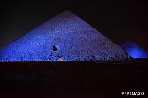 The Pyramid of Khufu, the largest of the Great Pyramids of Giza is lit in blue in honor of World Autism Awareness Day, on the outskirts of Cairo, Egypt on April 02, 2017. Photo by Amr Sayed