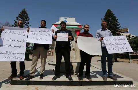 Palestinian employees paid by the Palestinian Authority take part in a protest against the decision of Palestinian goverment to deduct salaries of employees about 30%, in Gaza City April 5, 2017. Photo by Ashraf Amra
