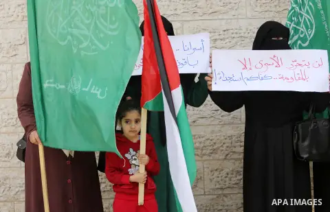 Palestinian women hold banners during a protest to mark Palestinian Prisoner Day, in front of Red cross office in Gaza city, on April 08, 2017. Photo by Mohammed Asad