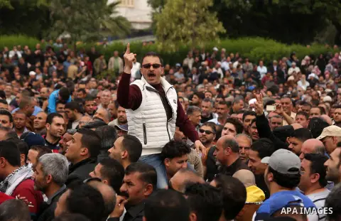 A Palestinian Authority employee chants slogans during a demonstration against the decision to reduce their salaries in Gaza City on April 8, 2017. Photo by Ashraf Amra