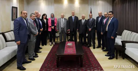 Palestinian Prime Minister, Rami Hamdallah, receives the annual report of the Anti-Corruption Commission for 2016, in the West Bank city of Ramallah, on April 13, 2017. Photo by Prime Minister Office