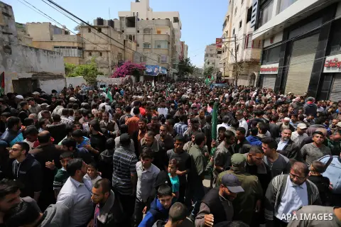 Hamas supporters hold crossed posters depicting Palestinian President Mahmoud Abbas and Palestinian Prime Minister Rami Hamdallah during a protest against them in Khan Younis in the southern Gaza Strip April 14, 2017. Ph...