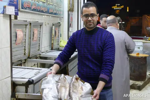 Egyptians buy the Herring or, salted fish during preparation for the upcoming the Sham El Nessim, or the Festival of Spring Breeze, which marks the beginning of spring, in Cairo, on April 14, 2017. Photo by Amr Sayed