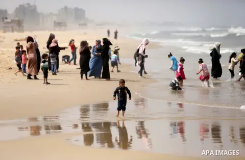 Palestinians enjoy their time at the beach of the Mediterranean sea on the coast of Gaza city, on April 15, 2017. Photo by Ashraf Amra