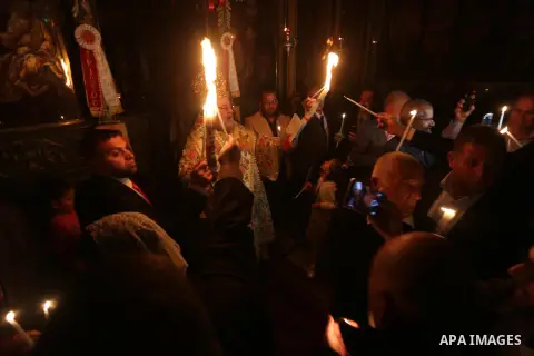 Orthodox Christian worshippers attend a prayer during the Easter Eve mass at the St. Porphyrios church in Gaza City, Saturday, April 15, 2017. Christians have gathered at the church for the fire ceremony that celebrates...