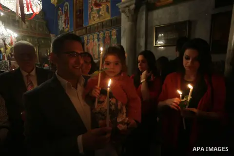Orthodox Christian worshippers attend a prayer during the Easter Eve mass at the St. Porphyrios church in Gaza City, Saturday, April 15, 2017. Christians have gathered at the church for the fire ceremony that celebrates...