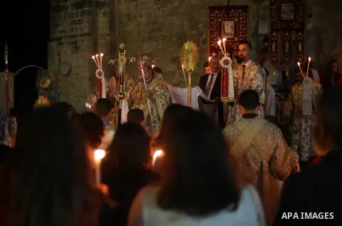 Orthodox Christian worshippers attend a prayer during the Easter Eve mass at the St. Porphyrios church in Gaza City, Saturday, April 15, 2017. Christians have gathered at the church for the fire ceremony that celebrates...
