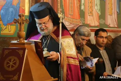 Orthodox Christian worshippers attend a prayer during the Easter Eve mass at the St. Porphyrios church in Gaza City, Saturday, April 15, 2017. Christians have gathered at the church for the fire ceremony that celebrates...