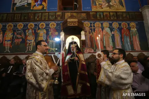 Orthodox Christian worshippers attend a prayer during the Easter Eve mass at the St. Porphyrios church in Gaza City, Saturday, April 15, 2017. Christians have gathered at the church for the fire ceremony that celebrates...