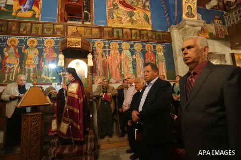 Orthodox Christian worshippers attend a prayer during the Easter Eve mass at the St. Porphyrios church in Gaza City, Saturday, April 15, 2017. Christians have gathered at the church for the fire ceremony that celebrates...