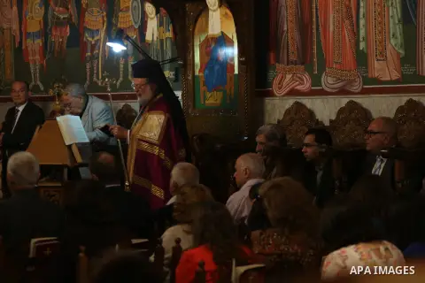 Orthodox Christian worshippers attend a prayer during the Easter Eve mass at the St. Porphyrios church in Gaza City, Saturday, April 15, 2017. Christians have gathered at the church for the fire ceremony that celebrates...