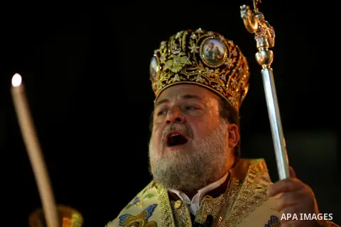 Archbishop Alexios leads the Easter Eve mass prayer at the St. Porphyrios church in Gaza City, Saturday, April 15, 2017. Christians have gathered at the church for the fire ceremony that celebrates Jesus' resurrection. P...