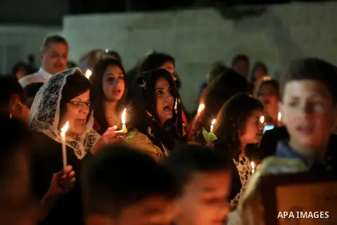 Orthodox Christian worshippers attend a prayer during the Easter Eve mass at the St. Porphyrios church in Gaza City, Saturday, April 15, 2017. Christians have gathered at the church for the fire ceremony that celebrates...
