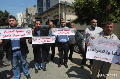 Union of the Palestinian syndicates members hold banners during a protest against Israeli blockade, in Gaza city, on April 19, 2017. Photo by Mohammed Asad