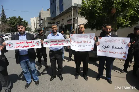 Union of the Palestinian syndicates members hold banners during a protest against Israeli blockade, in Gaza city, on April 19, 2017. Photo by Mohammed Asad