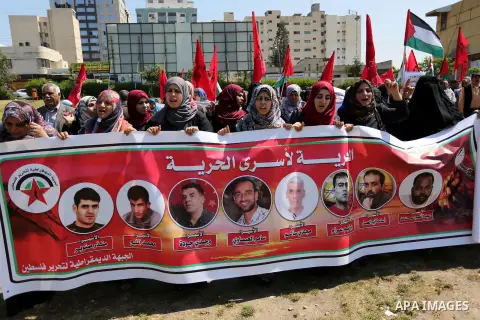 Palestinian supporters of the Democratic Front for the Liberation of Palestine (DFLP), hold banners during a protest to show solidarity with Palestinian prisoners on hunger strike in Israeli jails, in Gaza city on April...
