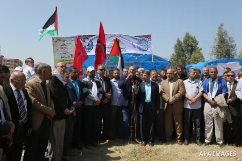 Palestinian supporters of the Democratic Front for the Liberation of Palestine (DFLP), hold banners during a protest to show solidarity with Palestinian prisoners on hunger strike in Israeli jails, in Gaza city on April...