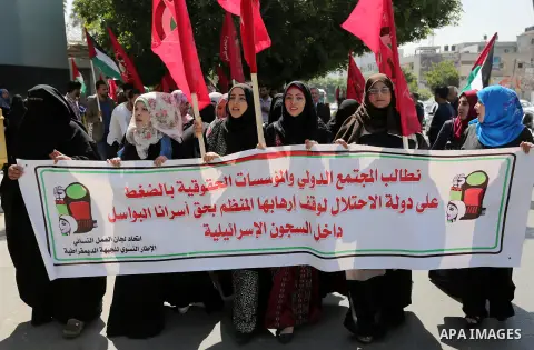 Palestinian supporters of the Democratic Front for the Liberation of Palestine (DFLP), hold banners during a protest to show solidarity with Palestinian prisoners on hunger strike in Israeli jails, in Gaza city on April...