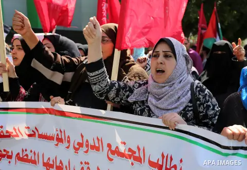 Palestinian supporters of the Democratic Front for the Liberation of Palestine (DFLP), hold banners during a protest to show solidarity with Palestinian prisoners on hunger strike in Israeli jails, in Gaza city on April...