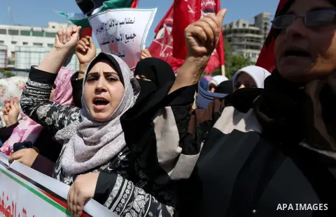 Palestinian supporters of the Democratic Front for the Liberation of Palestine (DFLP), hold banners during a protest to show solidarity with Palestinian prisoners on hunger strike in Israeli jails, in Gaza city on April...