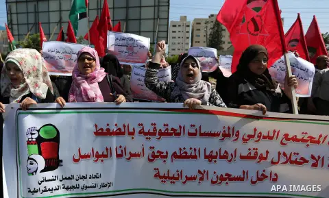 Palestinian supporters of the Democratic Front for the Liberation of Palestine (DFLP), hold banners during a protest to show solidarity with Palestinian prisoners on hunger strike in Israeli jails, in Gaza city on April...