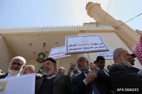 Members of the Palestine Scholars Association take part in a protest against the Israeli blockade of the Gaza Strip in Gaza city on April 19, 2017. Photo by Ashraf Amra