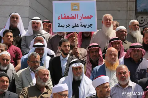 Members of the Palestine Scholars Association take part in a protest against the Israeli blockade of the Gaza Strip in Gaza city on April 19, 2017. Photo by Ashraf Amra