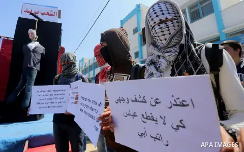 Palestinian children take part in a protest against Palestinian Authority decision to reduce employees salaries and crisis of power outages, in Jabalia refugee camp in the northern Gaza Strip on April 19, 2017. Photo by...