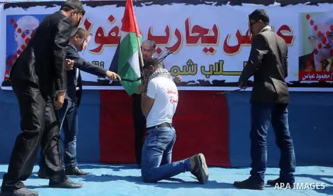 Palestinian children take part in a protest against Palestinian Authority decision to reduce employees salaries and crisis of power outages, in Jabalia refugee camp in the northern Gaza Strip on April 19, 2017. Photo by...
