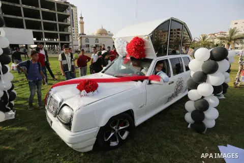 Palestinians look "Cinderella" vehicle in Gaza City on April 22, 2017. Made up of five different cars, it will be rented out for use at marriage ceremonies. Photo by Ashraf Amra