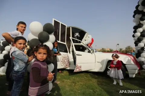 Palestinians look "Cinderella" vehicle in Gaza City on April 22, 2017. Made up of five different cars, it will be rented out for use at marriage ceremonies. Photo by Ashraf Amra