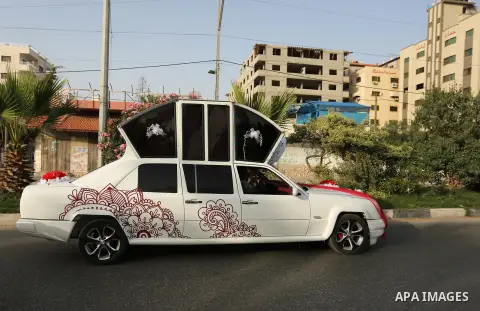 A Palestinian mechanic display his "Cinderella" vehicle in Gaza City on April 22, 2017. Made up of five different cars, it will be rented out for use at marriage ceremonies. Photo by Ashraf Amra
