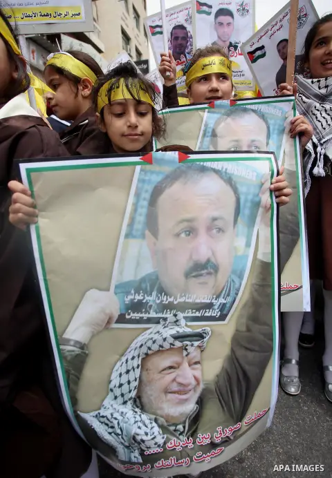 Palestinian protesters hold banners during a demonstration in solidarity with Palestinian prisoners on hunger strike in Israeli jails, in the West Bank of Nablus on April 23, 2017. Some 1,500 Palestinian prisoners have j...