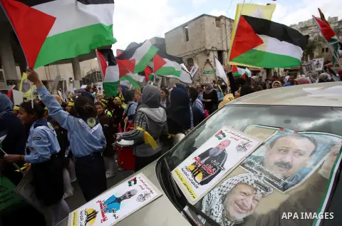 Palestinian protesters hold banners during a demonstration in solidarity with Palestinian prisoners on hunger strike in Israeli jails, in the West Bank of Nablus on April 23, 2017. Some 1,500 Palestinian prisoners have j...