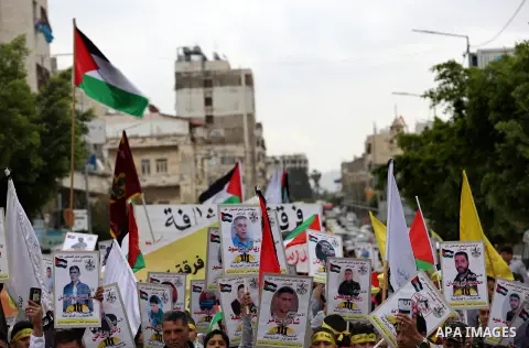 Palestinian protesters hold banners during a demonstration in solidarity with Palestinian prisoners on hunger strike in Israeli jails, in the West Bank of Nablus on April 23, 2017. Some 1,500 Palestinian prisoners have j...