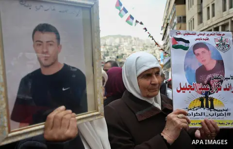 Palestinian protesters hold banners during a demonstration in solidarity with Palestinian prisoners on hunger strike in Israeli jails, in the West Bank of Nablus on April 23, 2017. Some 1,500 Palestinian prisoners have j...