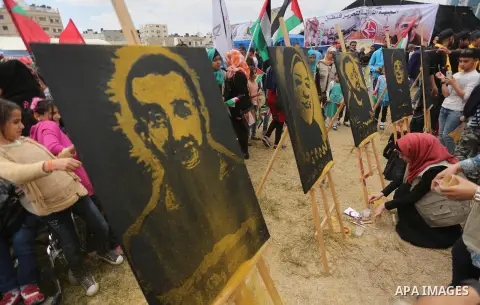 Palestinian protesters hold banners during a protest in solidarity with Palestinian prisoners on hunger strike in Israeli jails, in Gaza city on April 24, 2017. Some 1,500 Palestinian prisoners have joined the hunger str...