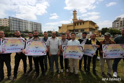 Palestinian protesters hold banners during a protest in solidarity with Palestinian prisoners on hunger strike in Israeli jails, in Gaza city on April 24, 2017. Some 1,500 Palestinian prisoners have joined the hunger str...