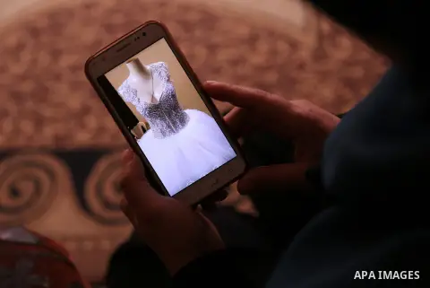 Manar Tafesh, 30, a Palestinian fashion designer works on knitting wedding dresses at her house with her husband to help him after he lost his work as tailor in the Palestinian territory occupied, in Gaza city on Feb. 14...