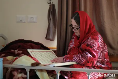 An elderly Palestinian woman reads a holy Koran at El Wafa elderly nursing home, in Gaza city on Feb. 12, 2017. El Wafa elderly nursing home was established in 1980 as one of programs of Al-Wafa charity association. El-W...