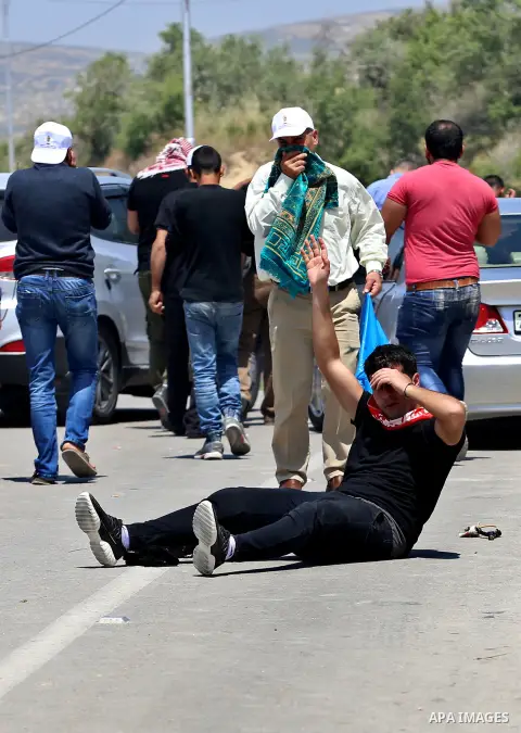 A Palestinian protester is evacuated after he was wounded during clashes with Israeli security forces at a protest in support of Palestinian prisoners on hunger strike in Israeli jails, in the West Bank village of al-Naq...