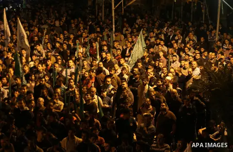 Supporters of the Palestinian Hamas movement hold banners during a protest against Palestinian President Mahmoud Abbas and Israeli blockade of the Gaza Strip, in Gaza city, on April 29, 2017. Photo by Mohammed Asad