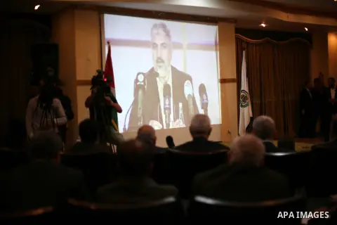 Hamas chief Khaled Mashaal, speaks via video conference during a meeting to announce Hamas political document (the document of general principles and policies), in Gaza city on May 01, 2017. Photo by Mohammed Asad